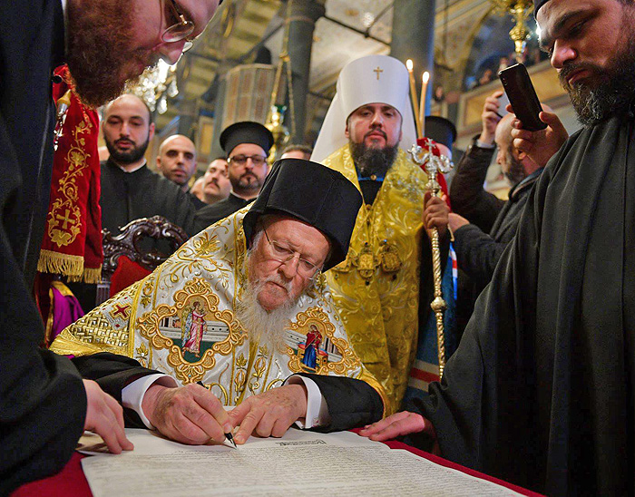 На церемонії у Стамбулі Вселенський патріарх Варфоломій підписує Томос про автокефалію Православної церкви України. Фото з сайту bbc.com