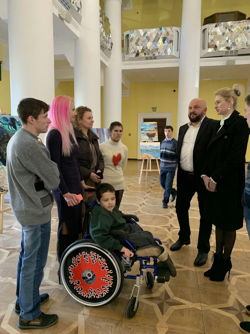 (Справа ліворуч): Співорганізатори акції – Евеліна Тітамир, голова ГО «Національна Асоціація Художників і скульпторів України», та Олег Тітамир, президент ГО «Українська організація захисту споживачів послуг» – спілкуються з учасниками виставки-аукціону. Фото надане автором